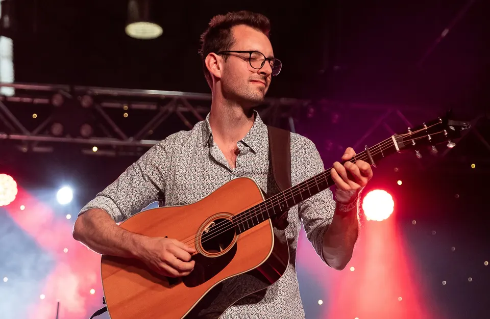 The band's guitarist playing on stage