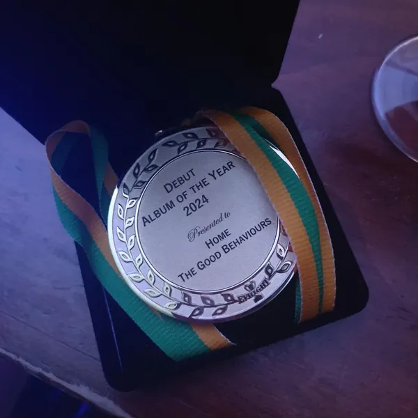 The Australian Folk Music Awards medal, Debut Album of the Year 2024, presented to Home by The Good Behaviours